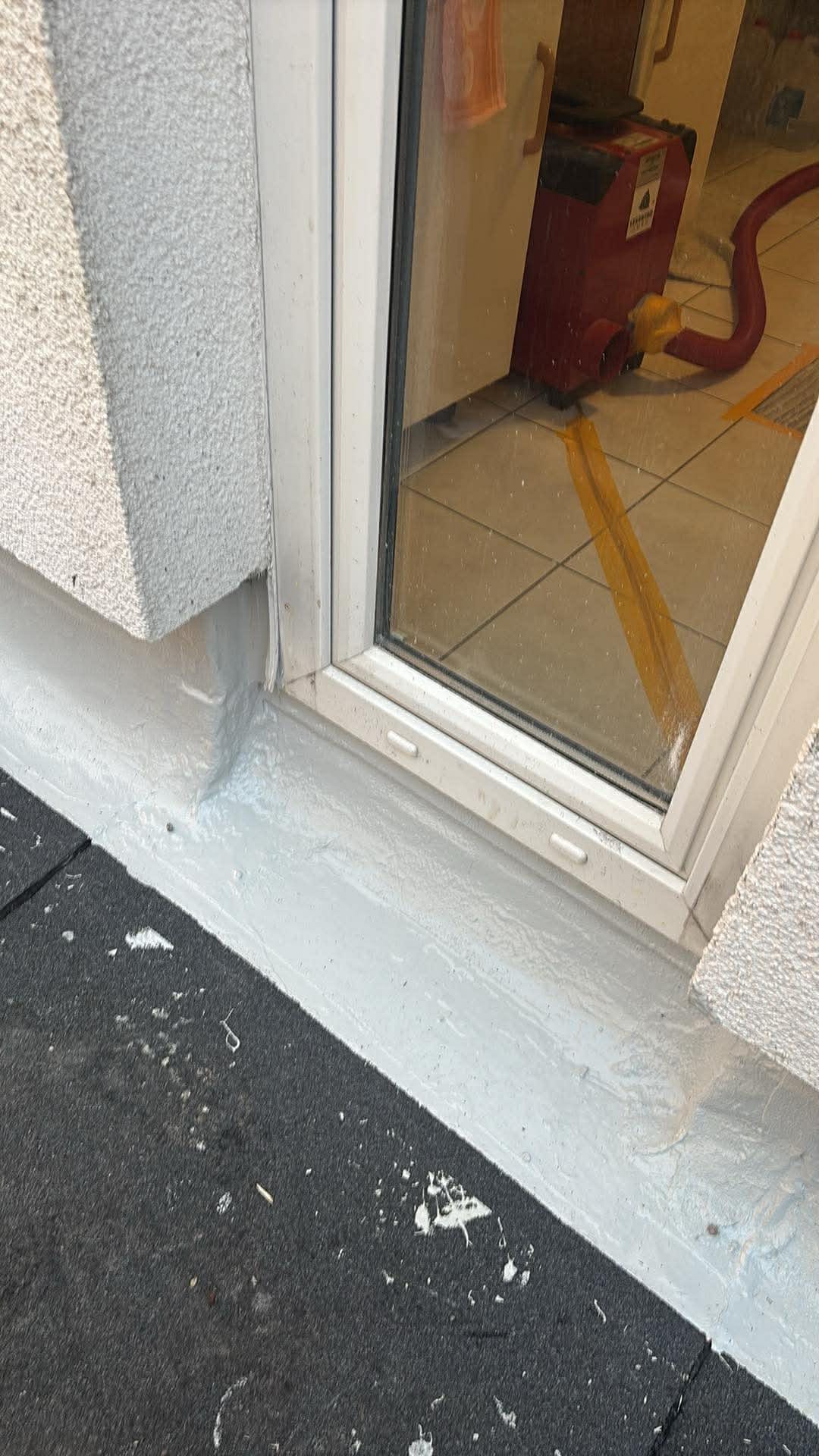Abgedichteter Türanschluss mit sauber ausgeführter Beschichtung im Sockelbereich vor Montage der äußeren Fensterbank